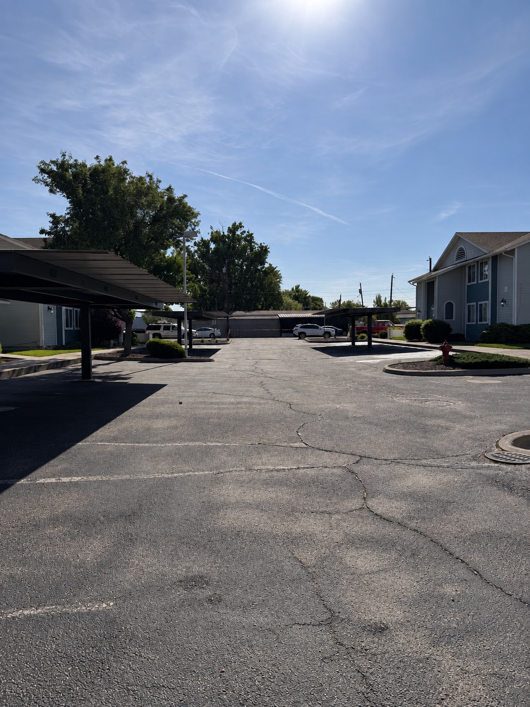 AI-generated reconstruction of the Cherry Lane parking lot with worn gray asphalt and visible unfilled cracks